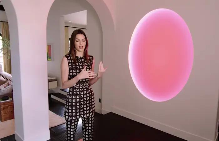 Kendall standing next to her James Turrell piece and discussing it